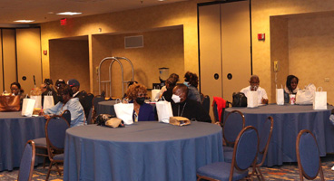 NFB members seated at tables during a convention gathering.